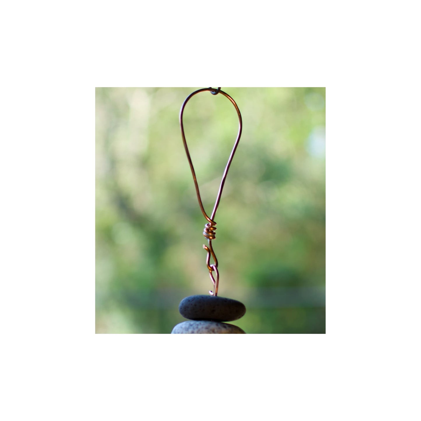 Copper hook on a stone with a blurred natural background