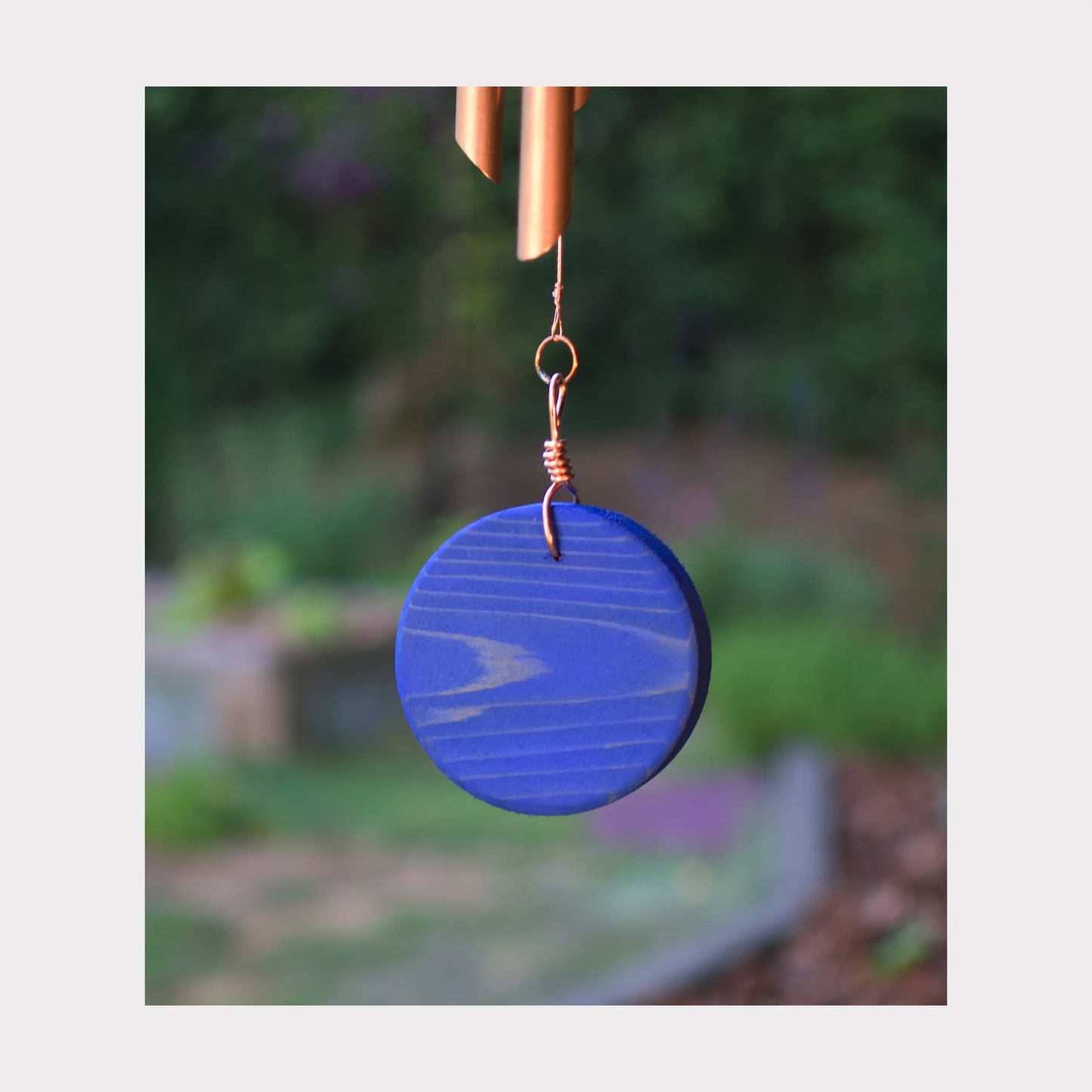 Eye-catching cobalt blue oiled cedar windsail for a large copper wind chime.