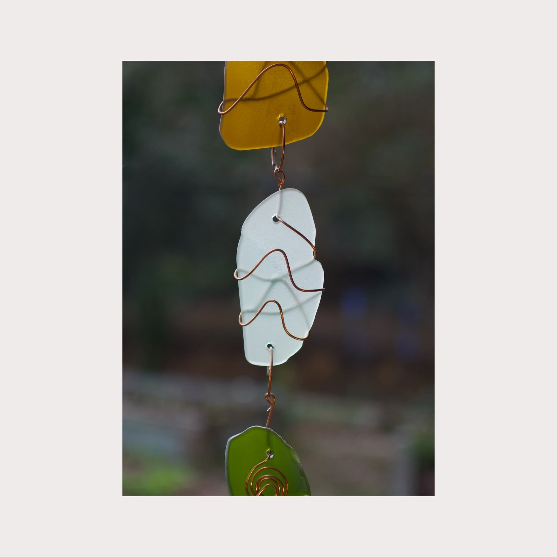 Decorative glass hanging with a blurred natural background