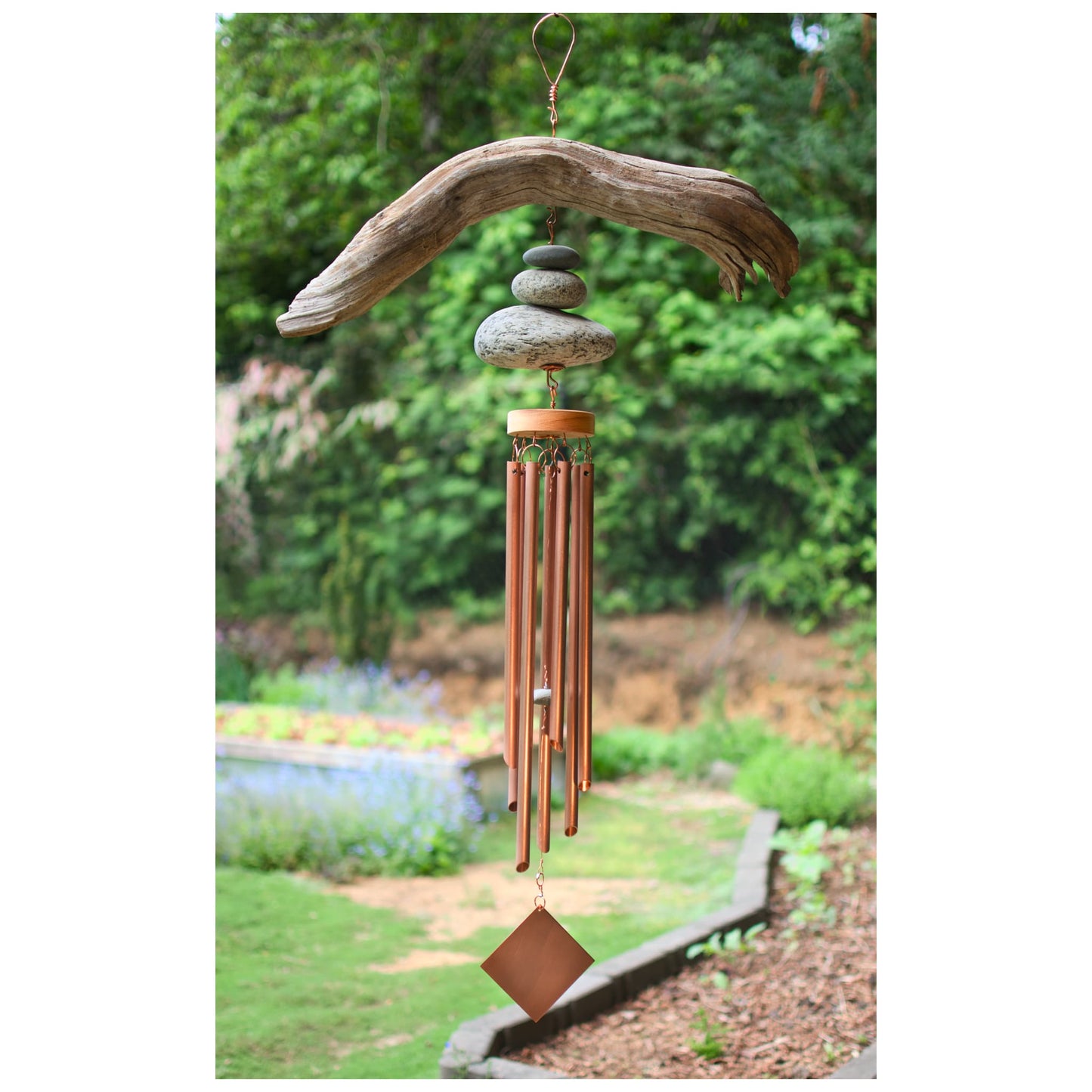Wind chime featuring large driftwood and beach stones, seven genuine copper chimes.