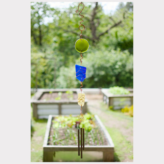 Wind chime featuring artist-made sea glass and three antiqued brass chimes.