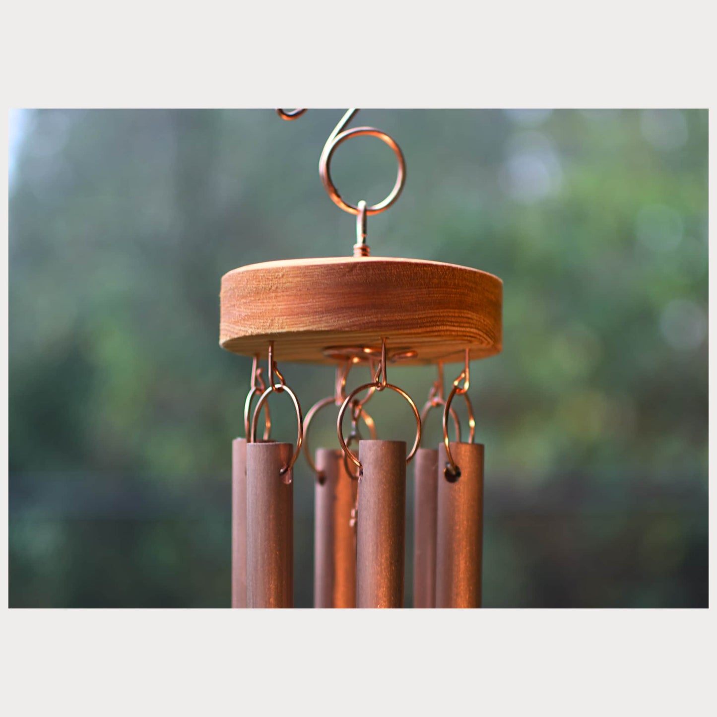 Zoom detail of a handmade copper wind chime with handcrafted copper hardware.